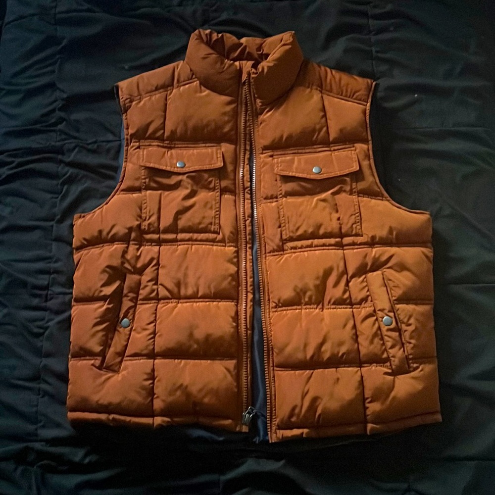 Orange sleeveless puffer jacket
